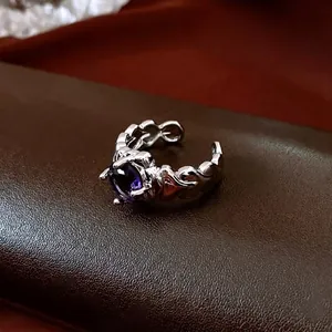 Vintage silver open ring featuring a large purple round gemstone and textured band