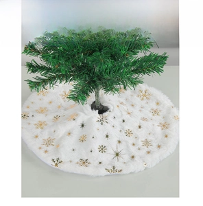 Close-up of white plush Christmas tree skirt with gold and silver snowflake patterns