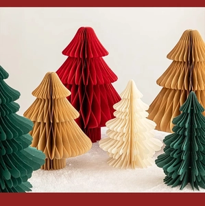 Detailed honeycomb paper Christmas trees in festive red, green, and cream on a snowy rug