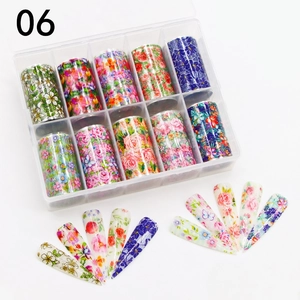 Detail of 10-roll floral nail art transfer foils in a transparent plastic storage box