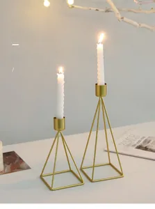 Detail of Nordic gold geometric metal candle holders with white spiral candles