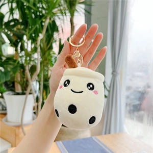 Close-up of a cute boba tea plush keychain with embroidery smile and gold ring