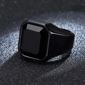 Close-up of men's square black gemstone ring with polished black metallic finish