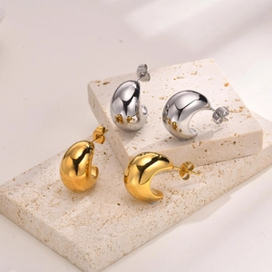 Thick hollow water drop stud earrings in gold and silver finish on stone base