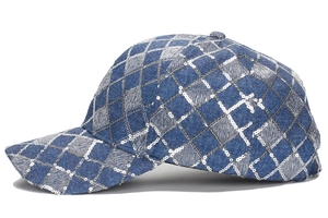 Close-up of blue denim baseball cap with silver sequin diamond lattice pattern detail.
