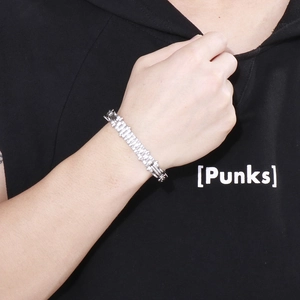 Close-up of a masculine silver steel chain bracelet on a male model's wrist