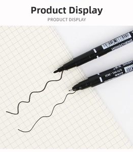 Dual-tip black permanent marker showing broad and fine lines on grid paper