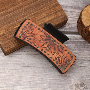 Western style leather hair claw clip with sunflower pattern and turquoise accents