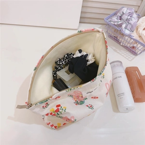 Detail of floral rabbit cotton makeup pouch with large opening for accessory storage