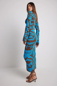 Close-up of slim-fit knitted ankle-length dress with blue and brown leopard animal print