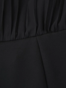 Detail of the elegant ruched chiffon dress with a belted waist and long sleeves