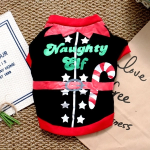 Detailed view of the Naughty Elf Christmas dog t-shirt flat laid on a textured mat