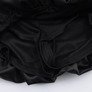 Detail of black satin fabric with elastic pleated waist and reinforced stitching