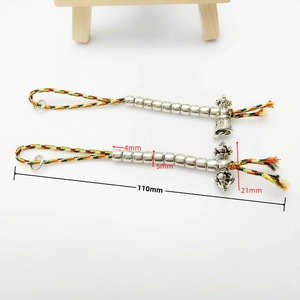 Detail showing 4mm beads and silver Vajra pendant on colorful hand-woven cord
