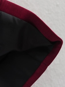 Detail of premium red plaid fabric stitching with smooth black inner lining and fine texture
