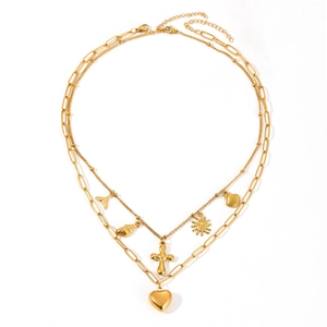 Double-layered gold necklace with heart, cross, shell, and fishtail charms on white background