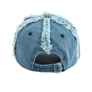 Vintage blue distressed denim baseball cap with frayed edges and adjustable metal buckle