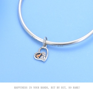 Detailed view of silver heart pendant with cat engraving and unique you are inscription