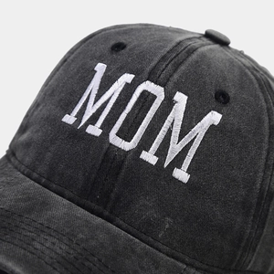 Close-up detail of white MOM embroidery on vintage washed cotton dark baseball cap