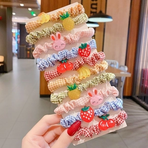 Detail of colorful plaid hair ties set with cartoon strawberry and rabbit resin charms