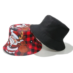 Detailed view of reversible Christmas bucket hat with red plaid Santa and reindeer patterns