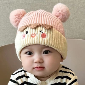 Pink and beige baby knit hat with pom poms and cute cartoon embroidery ear protection