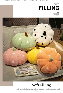 Detailed plush pumpkin pillows set in various colors on a modern grey sofa