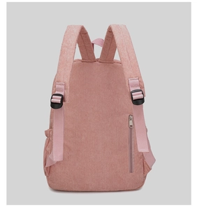 Detail of pink corduroy backpack featuring a secure back zipper pocket and side pocket