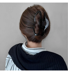Glossy black irregular hair claw clip for elegant updo styling on long hair