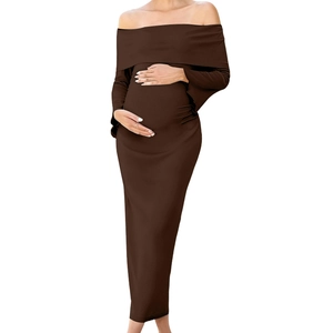 Detail of off-shoulder maternity dress in brown knit fabric with ruched side seams