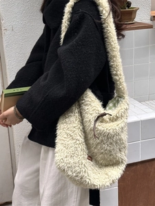 Fuzzy cream lamb wool tote bag with green checkered lining and brown drawstring detail