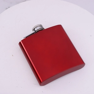 Portable 6oz red stainless steel hip flask displayed on a white round presentation plate