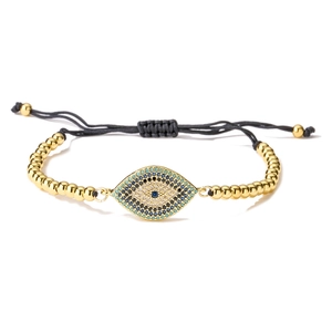 Macro detail of 18K gold-plated evil eye charm with micro-pave multicolored zircons
