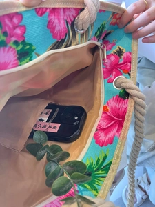 Interior detail of floral canvas tote bag showing zipper pocket and hemp rope handle