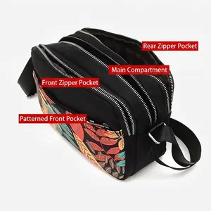 Black floral oxford crossbody bag with multiple zip pockets and adjustable strap