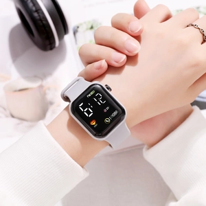 Wrist shot of a light grey silicone strap square LED digital watch for sports