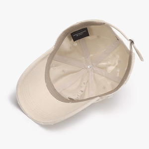 Distressed beige cotton baseball cap with torn details and interior view of the crown