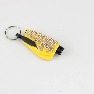 Macro view of a yellow diamond-studded 2-in-1 car safety tool keychain for window breaking