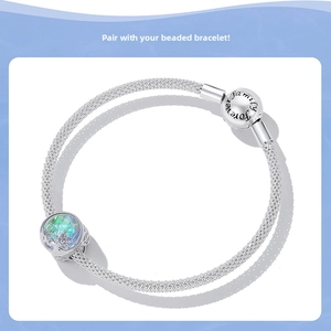 Detail of S925 silver charm bracelet showing aurora glass bead and family forever clasp