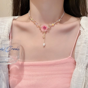 Elegant floral necklace featuring pink flower pendant with white pearl and crystal beads