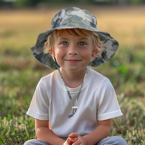 Close-up of kids dinosaur camo sun hat with adjustable windproof drawstring on a boy