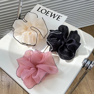 Detail of three oversized organza hair scrunchies with elegant contrast border stitching