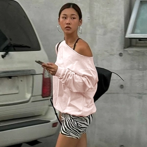 Detail of pink off-shoulder long sleeve sweatshirt and zebra print shorts for women
