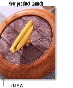 Detailed view of an irregular golden ring displayed in a wooden velvet jewelry box
