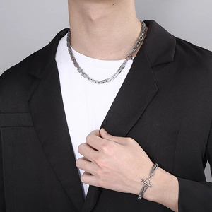 Detail of silver stainless steel rectangular chain necklace and toggle clasp bracelet