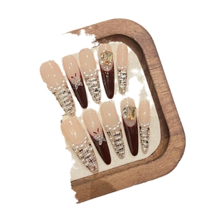 French tweed style press-on nails with deep red gradients and pearl embellishments