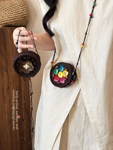Detail of bohemian handmade woven mini crossbody bags with coconut shell and bead accents