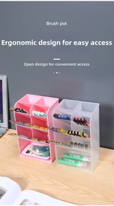 Detail of pink and clear slanted desk organizer with multiple slots and storage drawer