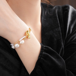 Detail of double-layer freshwater pearl bracelet with gold-plated beads and OT buckle