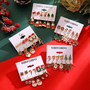 Festive Christmas earring set with Santa Claus, reindeer, and snowflake studs on card